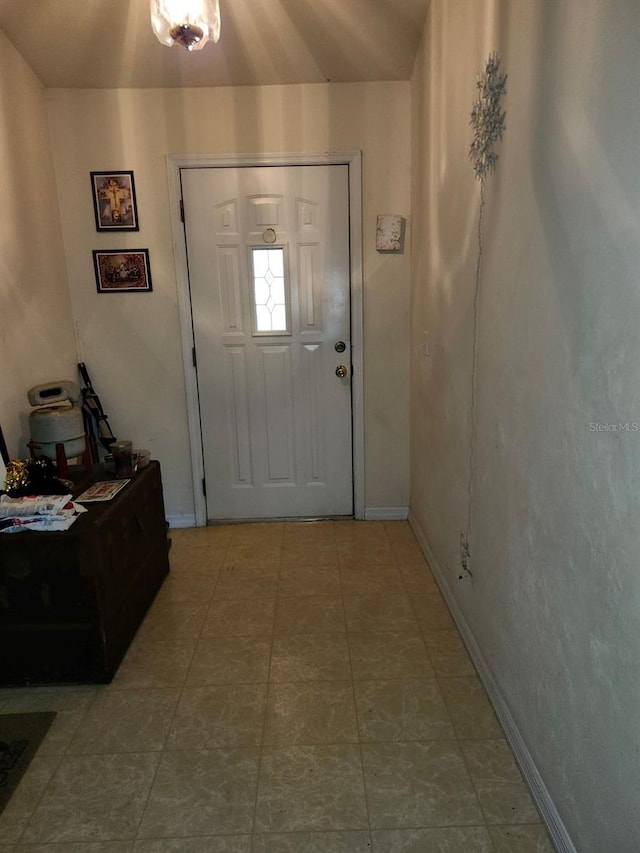 tiled entrance foyer with baseboards