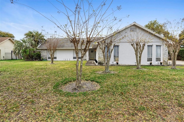 view of front of house with a front yard and stucco siding