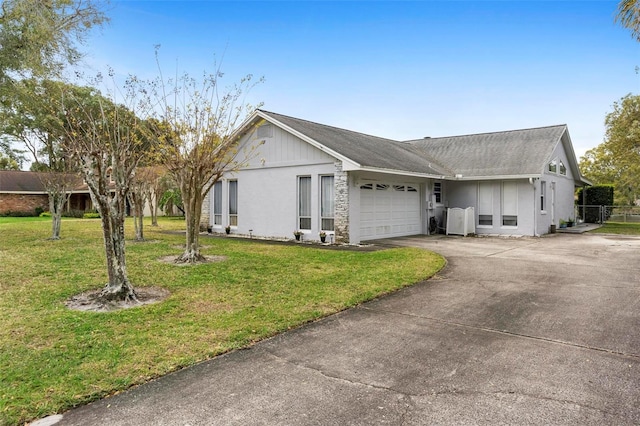 view of front facade with concrete driveway, a front lawn, and an attached garage