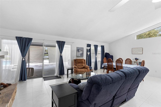 living area with vaulted ceiling, plenty of natural light, and light tile patterned floors