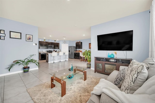 living room featuring light tile patterned floors, baseboards, and recessed lighting