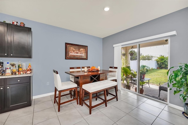 dining area featuring baseboards and light tile patterned flooring