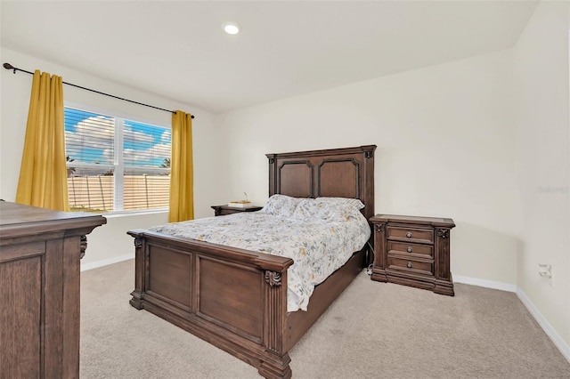 bedroom featuring light carpet, recessed lighting, and baseboards