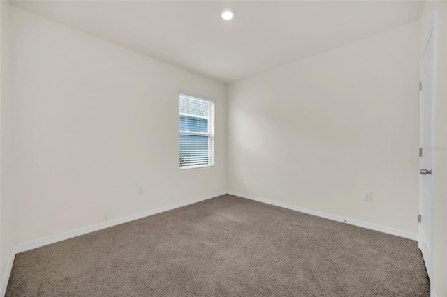 carpeted spare room featuring recessed lighting and baseboards