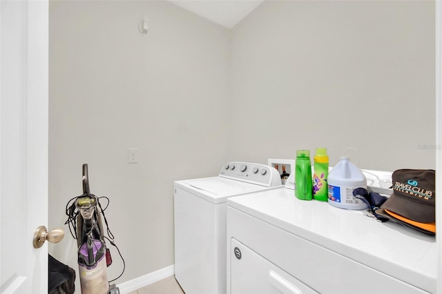 laundry area featuring laundry area, washing machine and clothes dryer, and baseboards