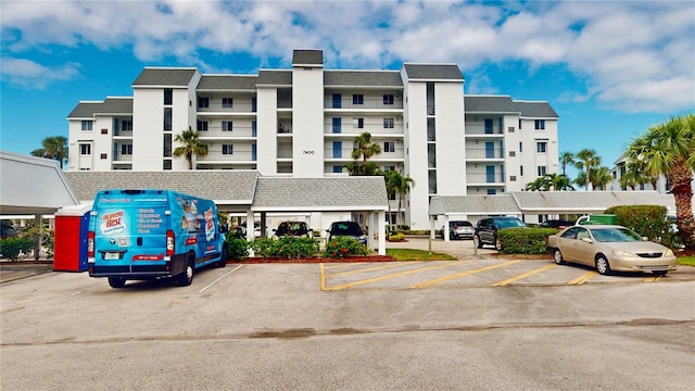 view of building exterior featuring uncovered parking