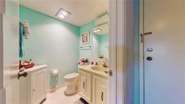 bathroom featuring vanity, tile patterned flooring, and toilet