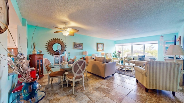 living room featuring a textured ceiling and a ceiling fan