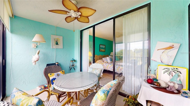 sunroom featuring ceiling fan