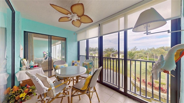 sunroom featuring a ceiling fan