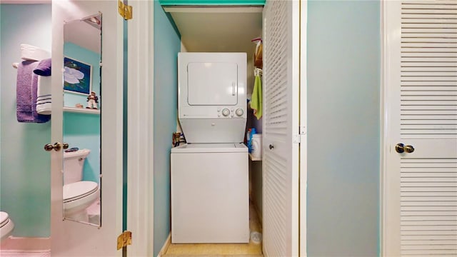 laundry area with stacked washer and clothes dryer and laundry area