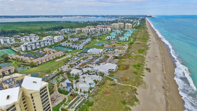 drone / aerial view featuring a view of the beach and a water view