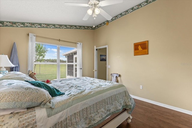 bedroom with ceiling fan, a textured ceiling, wood finished floors, and baseboards