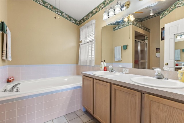 bathroom with a bath, a shower stall, a sink, and tile patterned floors