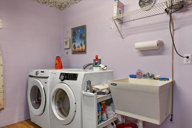 laundry room featuring laundry area, a sink, and washer and dryer