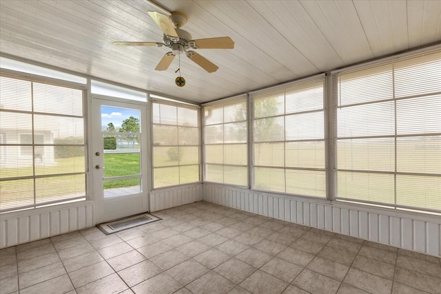 unfurnished sunroom featuring ceiling fan