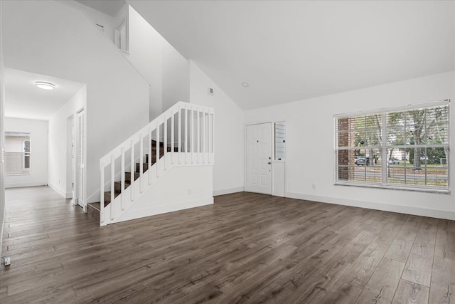 entryway with dark wood-style floors, baseboards, stairway, and high vaulted ceiling