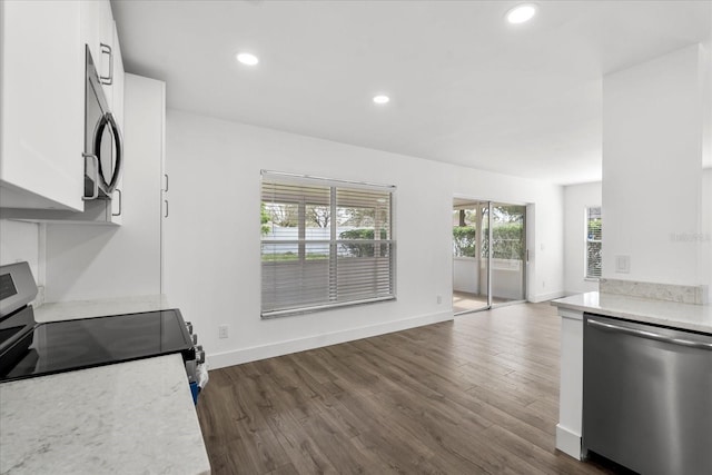 kitchen featuring appliances with stainless steel finishes, recessed lighting, white cabinets, and dark wood-type flooring