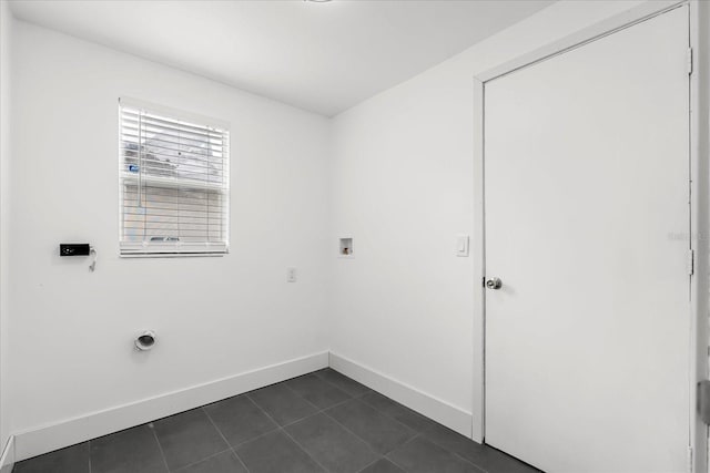 laundry area with laundry area, baseboards, dark tile patterned flooring, hookup for an electric dryer, and washer hookup