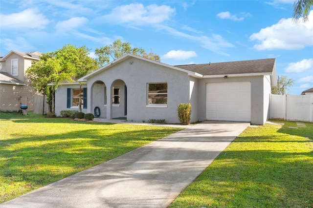 view of front of house featuring driveway, an attached garage, fence, and stucco siding