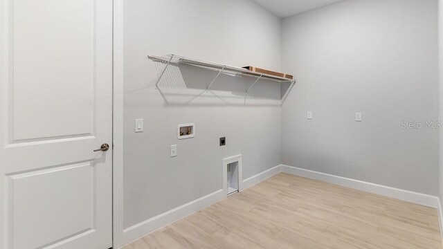 5641 Nevis Ter, Kissimmee, FL 34758 - clothes washing area featuring washer hookup, hookup for an electric dryer, baseboards, and light wood-type flooring