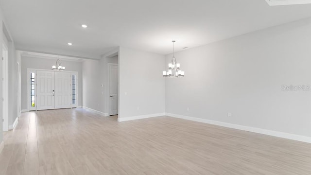 5641 Nevis Ter, Kissimmee, FL 34758 - entrance foyer with a chandelier, baseboards, light wood-type flooring, and recessed lighting