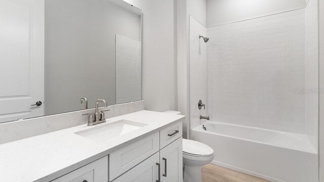 5641 Nevis Ter, Kissimmee, FL 34758 - full bath featuring toilet, vanity, wood finished floors, and shower / bath combination