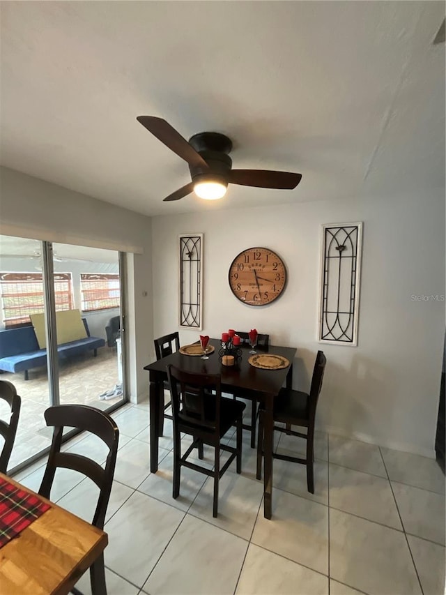 dining room featuring light tile patterned floors and a ceiling fan