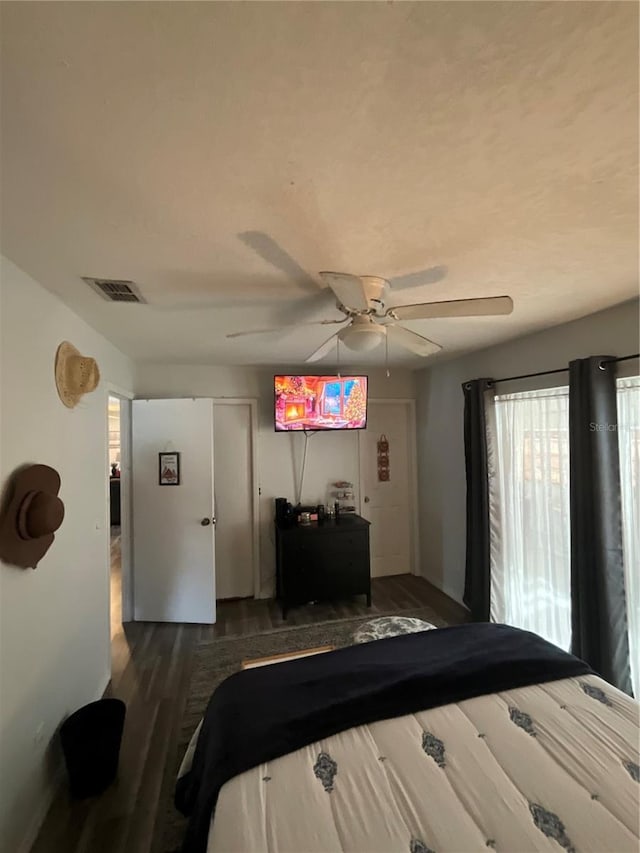 bedroom with visible vents, ceiling fan, and wood finished floors