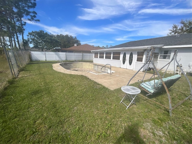 back of house featuring a patio area, a fenced backyard, and a lawn