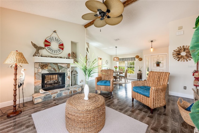 living area featuring visible vents, baseboards, lofted ceiling, wood finished floors, and a stone fireplace