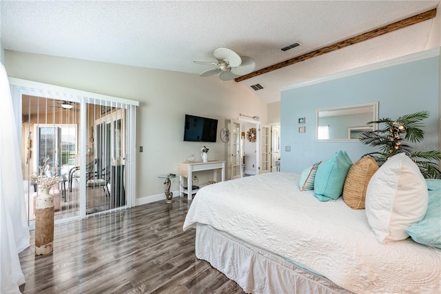 bedroom with access to exterior, visible vents, vaulted ceiling, a textured ceiling, and wood finished floors