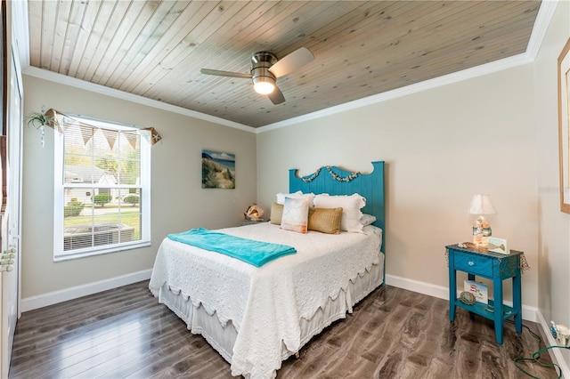 bedroom with ornamental molding, dark wood finished floors, and baseboards