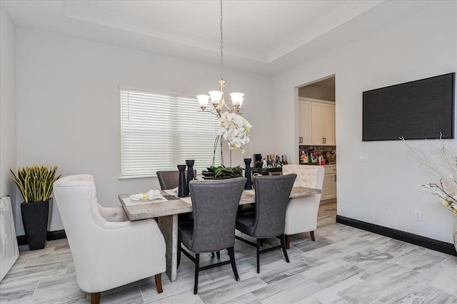 15724 Cutter Sail Pl, Winter Garden, FL 34787 - dining space with a chandelier, a tray ceiling, and baseboards