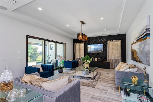 15724 Cutter Sail Pl, Winter Garden, FL 34787 - living room with recessed lighting, a raised ceiling, visible vents, and wood finished floors