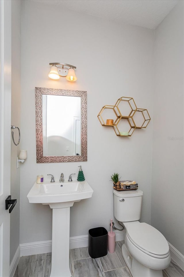 15724 Cutter Sail Pl, Winter Garden, FL 34787 - half bathroom featuring wood finish floors, baseboards, and toilet