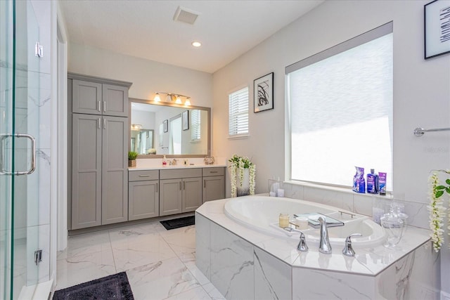 15724 Cutter Sail Pl, Winter Garden, FL 34787 - full bath featuring a stall shower, visible vents, a garden tub, marble finish floor, and vanity