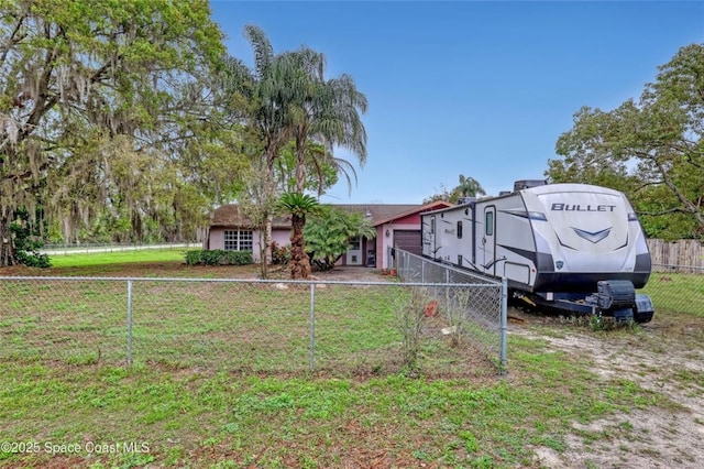 view of front facade with a fenced backyard and a front lawn