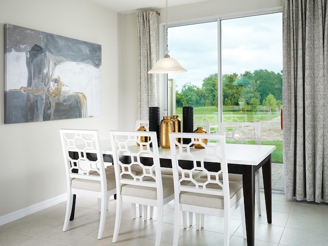 dining space with tile patterned flooring and baseboards