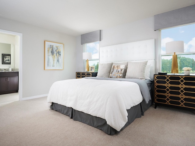 bedroom with light colored carpet, connected bathroom, and baseboards