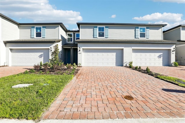 4365 Switchgrass Ln, Saint Cloud, FL 34772 - view of front of house featuring an attached garage, decorative driveway, and stucco siding
