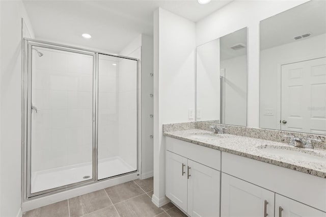 4365 Switchgrass Ln, Saint Cloud, FL 34772 - full bathroom with a stall shower, double vanity, a sink, and visible vents