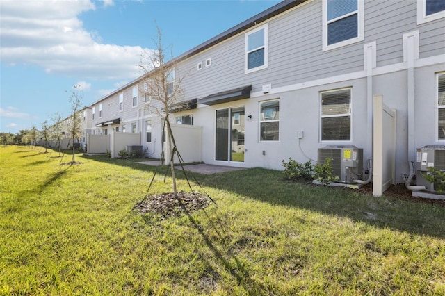 4365 Switchgrass Ln, Saint Cloud, FL 34772 - back of property featuring cooling unit, a yard, and stucco siding