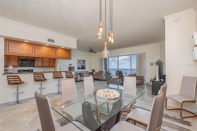 3203 S Washington Ave Unit 1002, Titusville, FL 32780 - dining area featuring a textured ceiling, visible vents, baseboards, a ceiling fan, and ornamental molding