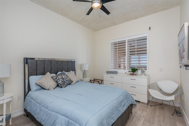 3203 S Washington Ave Unit 1002, Titusville, FL 32780 - bedroom with a ceiling fan, light wood-style flooring, and baseboards