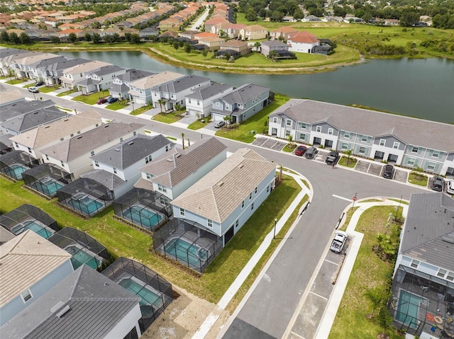 birds eye view of property with a water view and a residential view