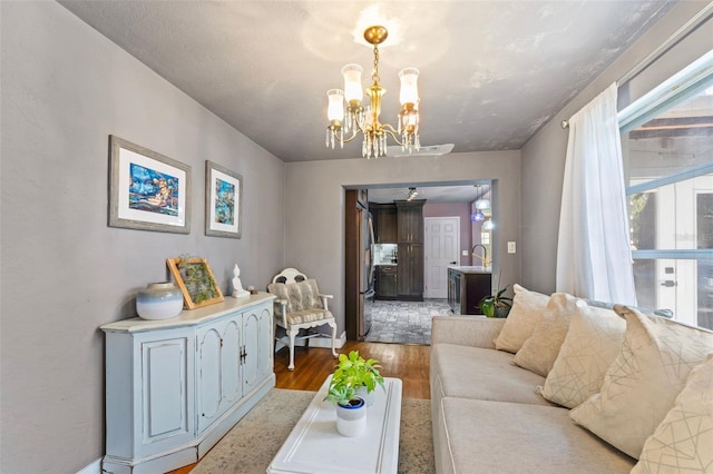 living room featuring a notable chandelier and wood finished floors