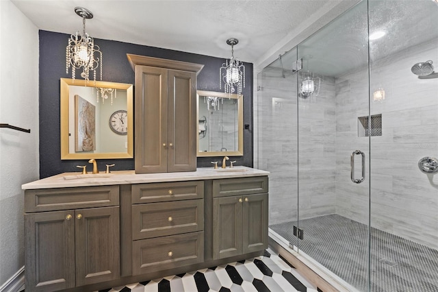 full bath featuring double vanity, a stall shower, and a sink