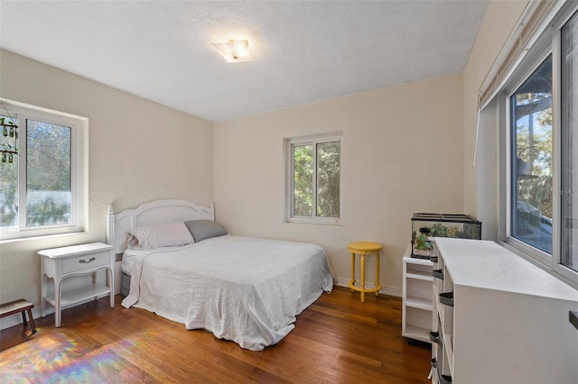 bedroom with baseboards and hardwood / wood-style flooring