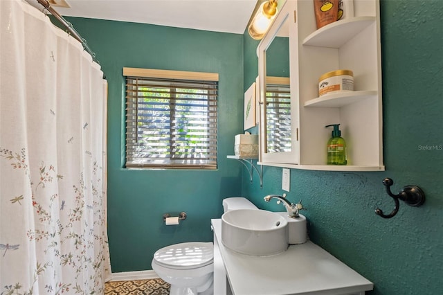 full bath featuring curtained shower, toilet, vanity, and baseboards